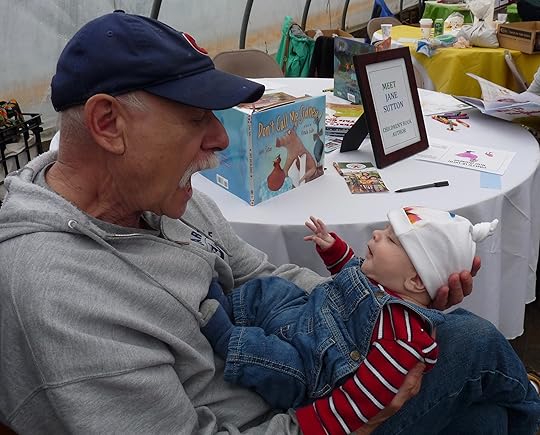 Grandpa Al converses with his grandson, who dressed for a farm occasion.
