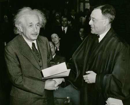 Albert Einstein receives his certificate of American citizenship from Judge Phillip Forman, 1 October 1940. Photo by New York World-Telegram and the Sun staff photographer: Al Aumuller. Public domain via Wikimedia Commons.