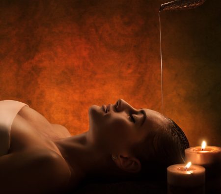 The girl has Shirodhara treatment - indian oil massage.