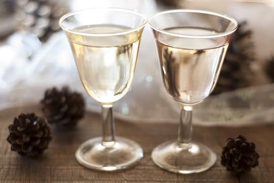 14491986 - two full celebratory wine glasses, in a glowing tabletop scene with christmas decorations
