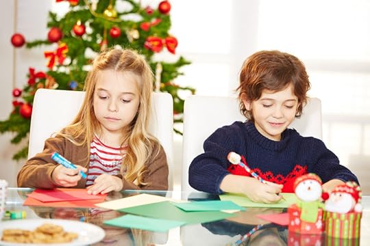 32925899 - two siblings drawing cards at christmas with handicrafts