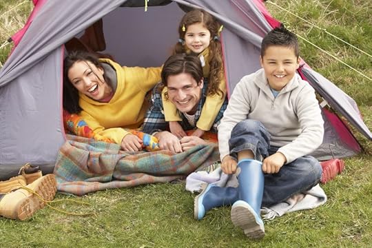10199284 - young family relaxing inside tent on camping holiday