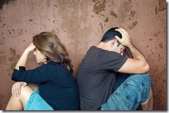 Divorce,fight,problems - Young couple angry at each other sitting back to back