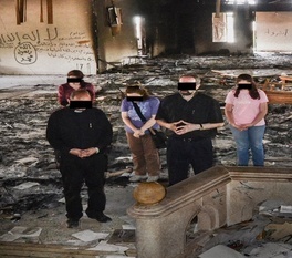Assyrian believers return to pray at their church after it was destroyed by Islamic extremist