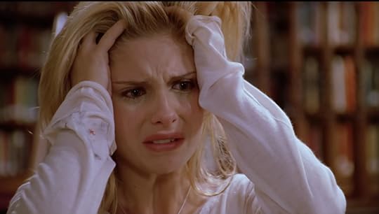 Buffy, crying, looking wounded, with her hands in her hair.