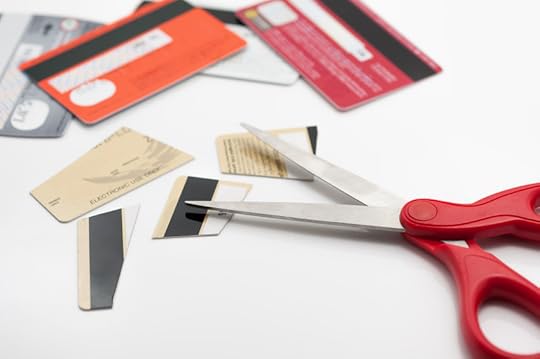 38432953 - cuting credit cards with scissors.