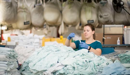 Karen Michael, PhD Candidate in Environmental and Occupational Hygiene in the Department of Environmental and Occupational Health Sciences, tests high-touch surfaces for three types of pathogens at an industrial hospital laundry facility in Seattle, WA.