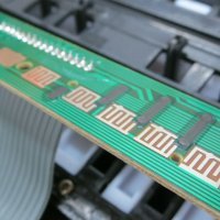 When the rubber buttons are taken away, we have the circuit board. It communicates with the synth sound board via a 16-conductor cable. I would need a carefully programmed microcontroller to poll the conductors. That would be too much trouble for me.