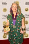 A welcome glass of champagne with the medal and award.