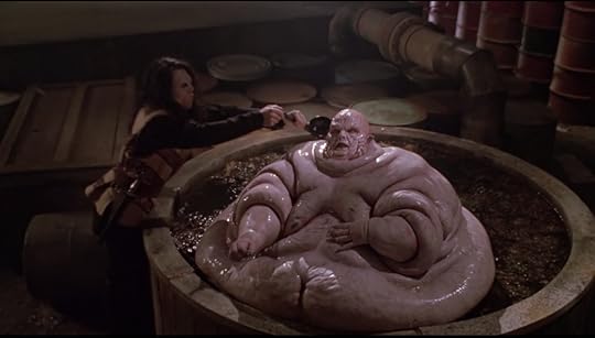 An enormously fat vampire, sitting naked in what appears to be chili. Another vampire is like, ladling liquid over him.