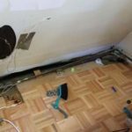 At the far end of the kitchen there was a huge hole in the wall, and wood floor