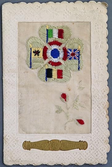 The card shows the flags and colours of five of the Allies on a four-leaf clover; clockwise from the top: Italy, the United Kingdom, Belgium,and Serbia, with the colours of France making up the central roundel. The flowers at the bottom are probably poppies.