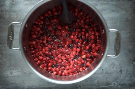 Ingredients for holiday berry jam in a pot.