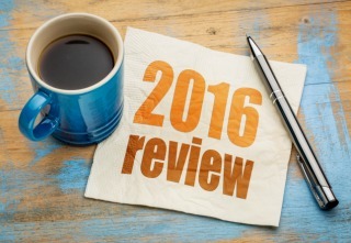 2016 review text on a napkin with a cup of coffee