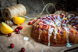 Round lemon cranberry glazed cake on the paper -thanksgiving and
