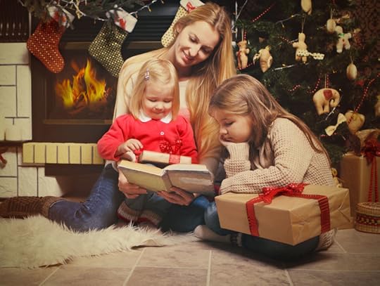 32948637 - young mother and her two little daughters with christmas gifts reading the book by a christmas tree in cozy living room with fireplace in winter