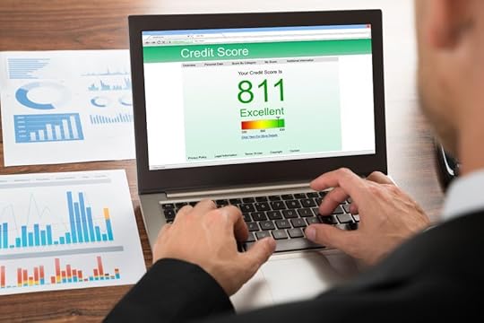 40245734 - close-up of a businessman checking credit score online on laptop