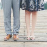 Photo of a man and woman from the knees down, standing close together