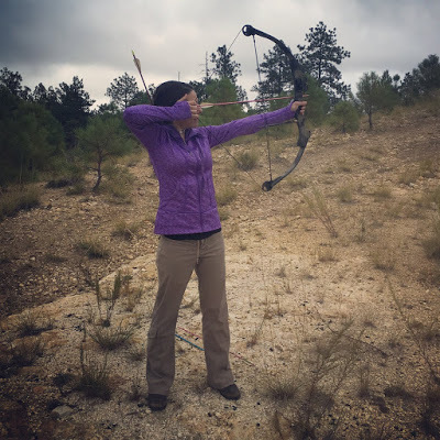 Sonja Stone shooting a Browning compound bow; bow and arrow in the desert