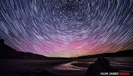 Startrails over Wales with the aurora behind.