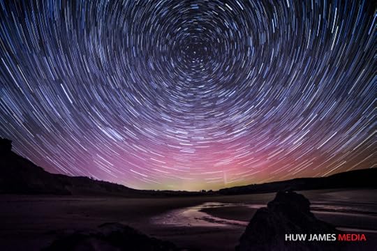 Startrails over Wales with the aurora behind.