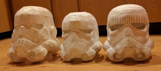 Full-resolution paper model alongside low-resolution prototypes.