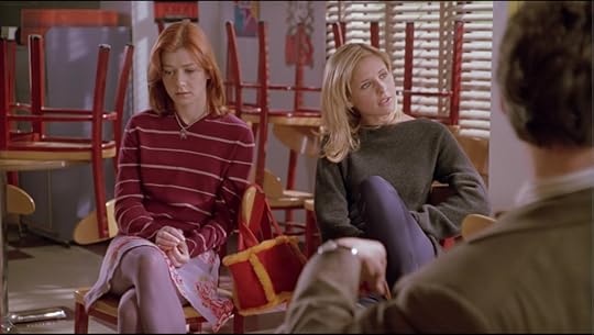 Willow sits next to Buffy. Buffy is still asking Xander questions, but we can tell from Willow's face that she gets it.