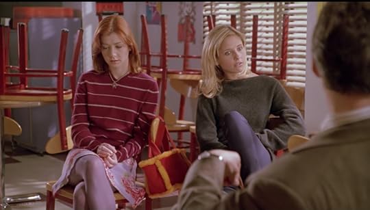 Same shot of Willow and Buffy sitting beside each other, only this time Buffy's facial expression makes it clear that she gets it now, too.