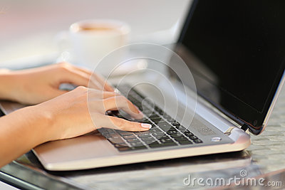 woman-hands-working-laptop-coffee-shop-close-up-table-47680808