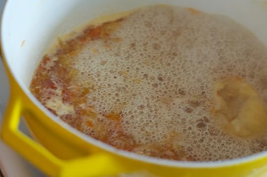 Bubbles on the surface of meyer lemon grapefruit marmalade as it cooks down