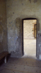 Inside a cell, door open.