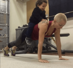 stay at home mom does pushups with her son on her back