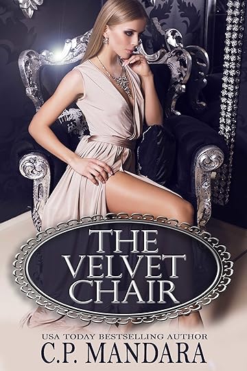sexy blond in beige silk dress sitting on the black armchair