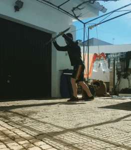 licinois gois doing tricep pushouts with a broomstick