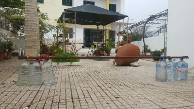using water bottles and a homemade bar to do arm work