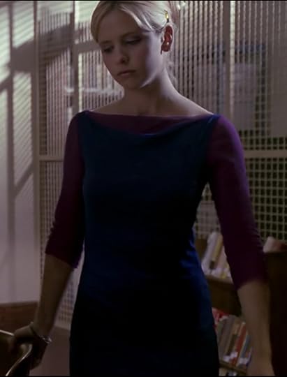Buffy is wearing a navy blue, sleeveless boatneck dress over what appears to be a magenta t-shirt. Upon closer inspection, it's some kind of chiffon. But it still looks super weird and her modern beehive hairdo is not helping the cause.