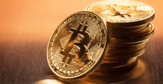 This is a close up photo of several gold plated bitcoins together symbolizing the bit coin market, modern technology, finance, internet, trading, etc.