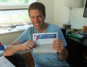Steven at my kitchen table with the acceptance letter for his second published play.