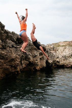 two people cliff diving: 
