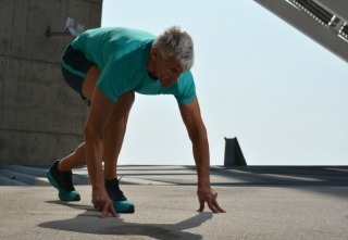 Elderly man practicing sports on the street