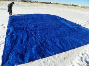 cutting tarp in snow