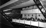 Diners eating in the dining room of a half-built R100.