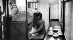 Maid prepares a meal in the kitchen of the R100.