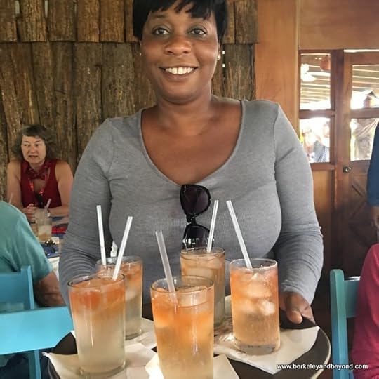 guide Monica helps serve drinks at Blue Crab Restaurant in Scarborough, Tobaygo
