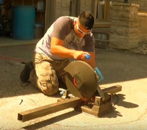 using a chop saw to create weight equipment for Kingdom Iron