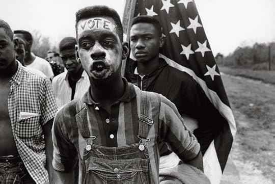 Bruce Davidson, Led by Martin Luther King Jr., a group of civil rights demonstrators march from Selma to Montgomery to fight for black suffrage. A young African American man with the word