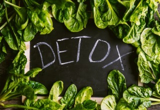 The inscription on the detox board and spinach around. Concept detox