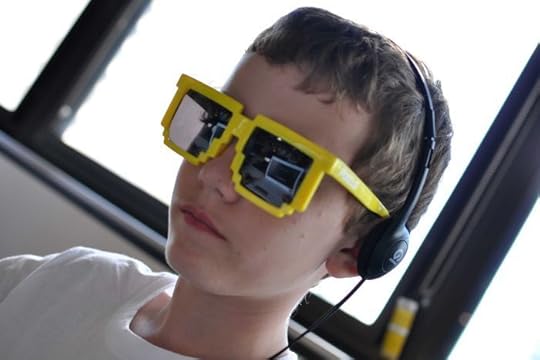 A boy wearing 8-bit sunglasses playing a special version of video game Minecraft