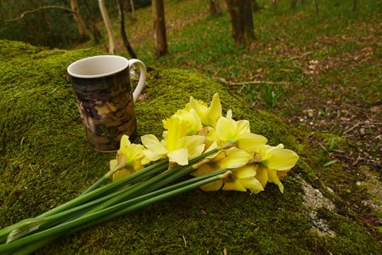 Coffee and daffodils in the woods
