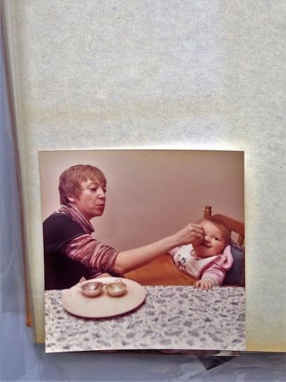You can see a ghostly outline of where a photo used to be in the upper left part of this image. The photo at the bottom has yellowed around its edges. Damaging chemical transfer occurred within this album.